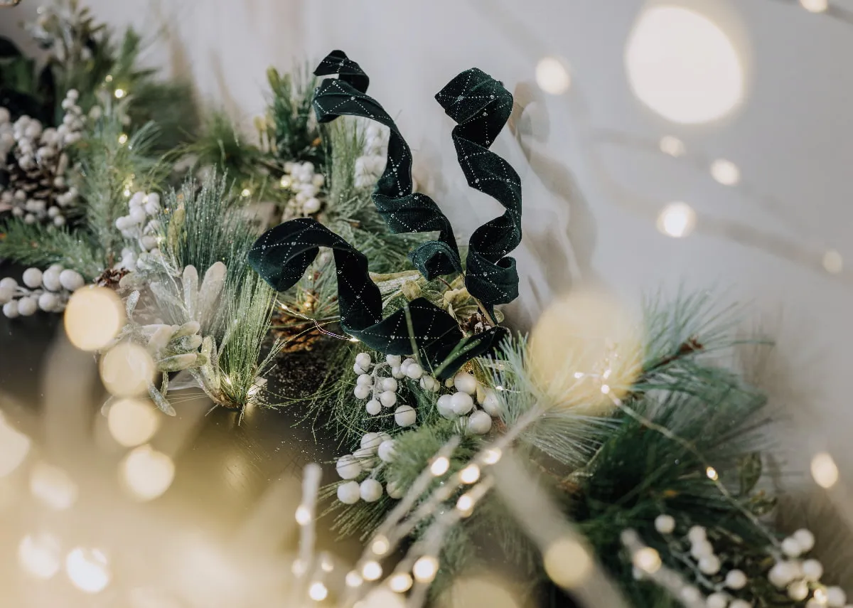 A lifestyle image of the Pearl & Pine wreath with the green velvet spray inserted to add volume.