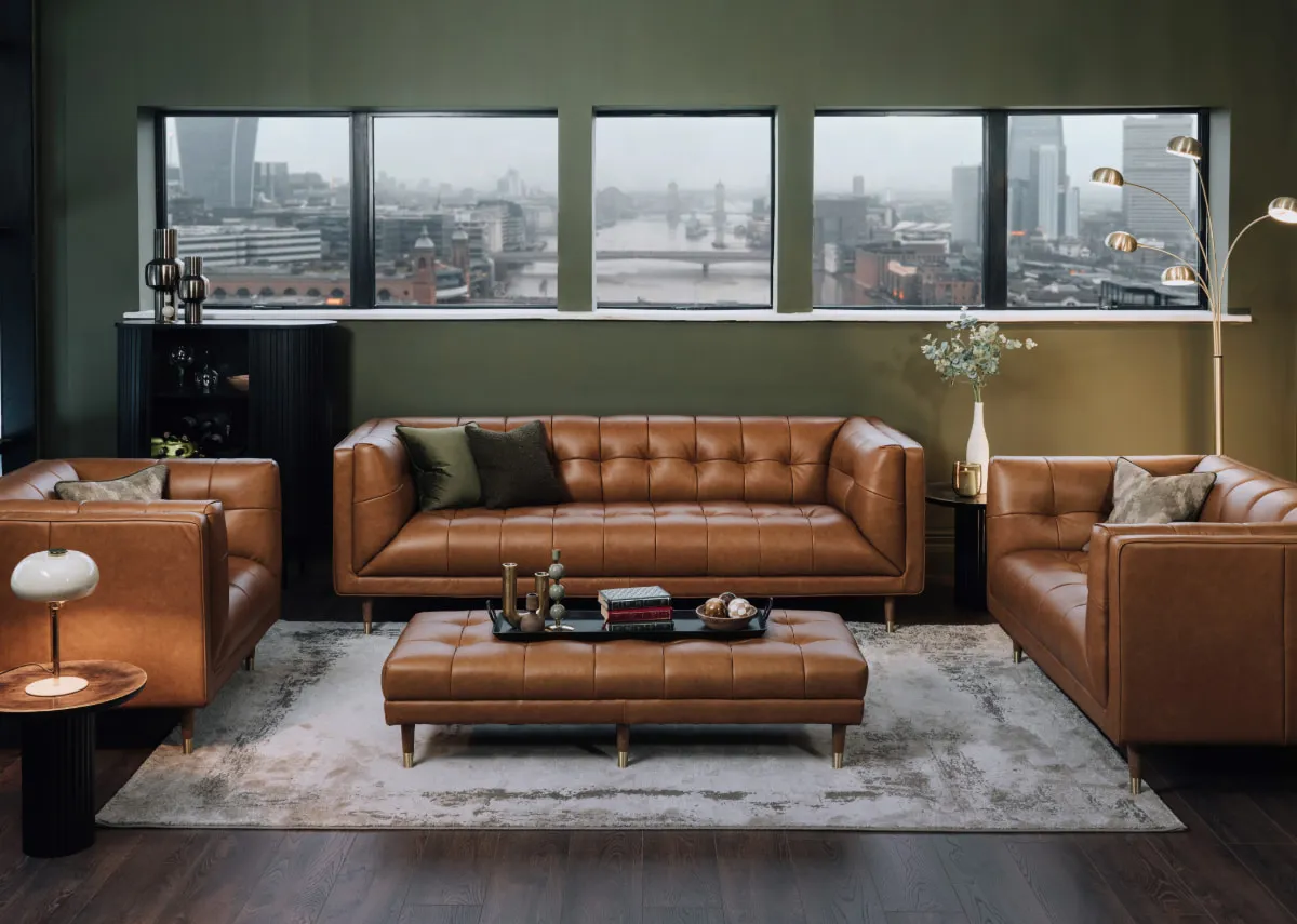 A lifestyle image of the Grace footstool with matching tan leather sofa range