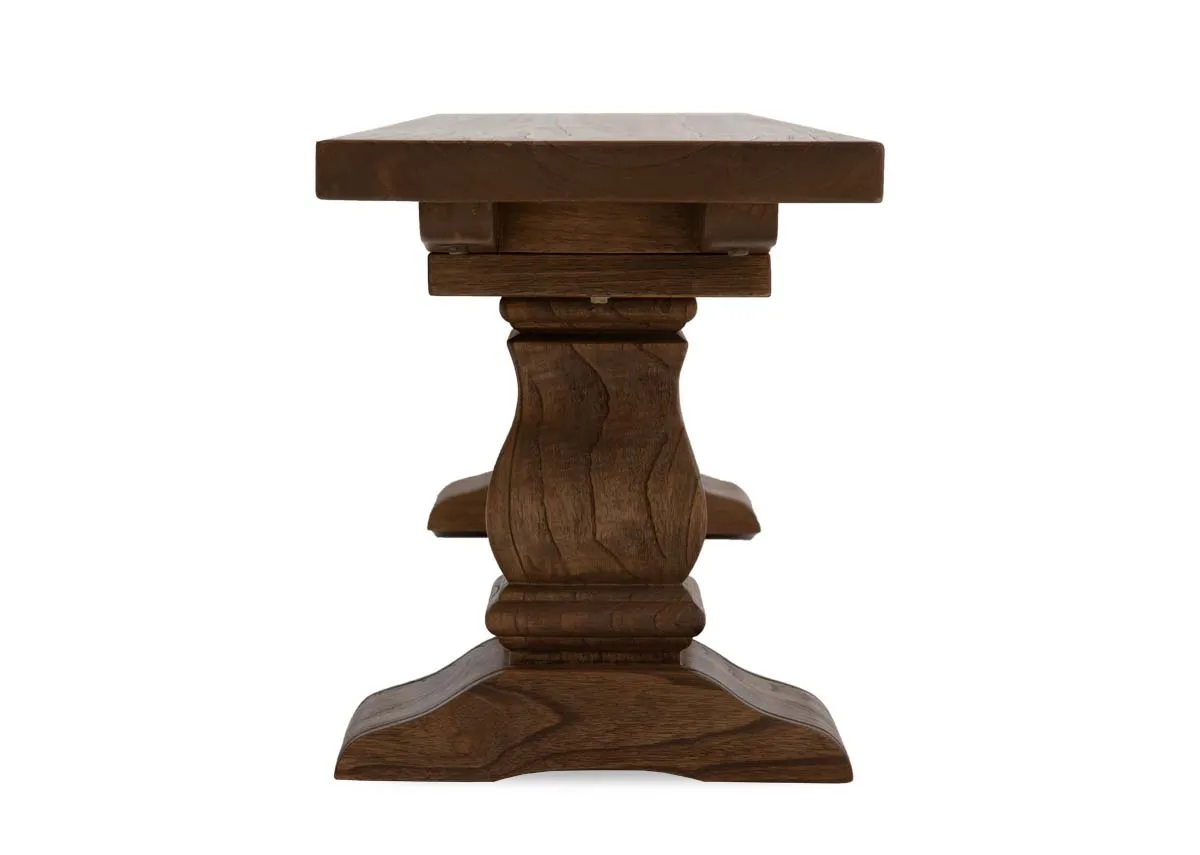 A reclaimed wood dining bench from EZ Livings Biarritz range. Side view of pedestal legs