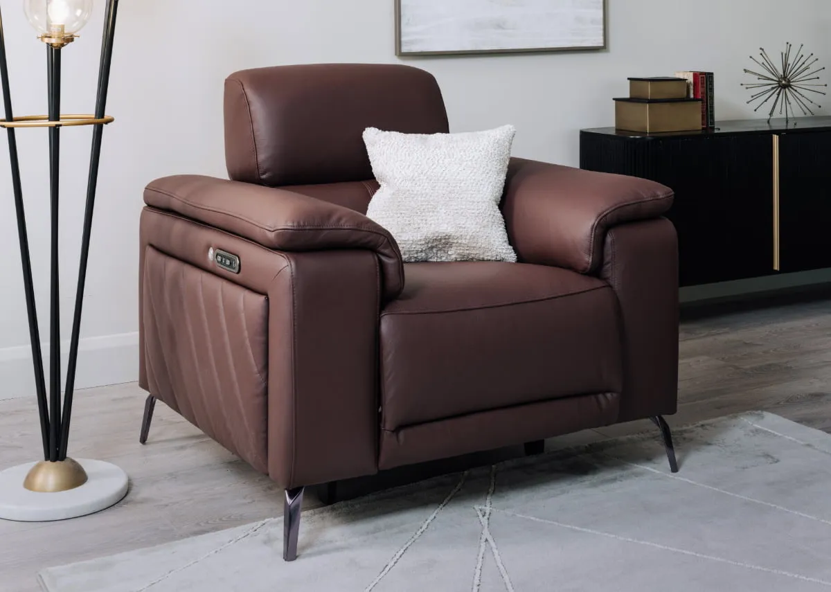 A lifestyle image of the Paige recliner with cream cushion with Ortez floor lamp