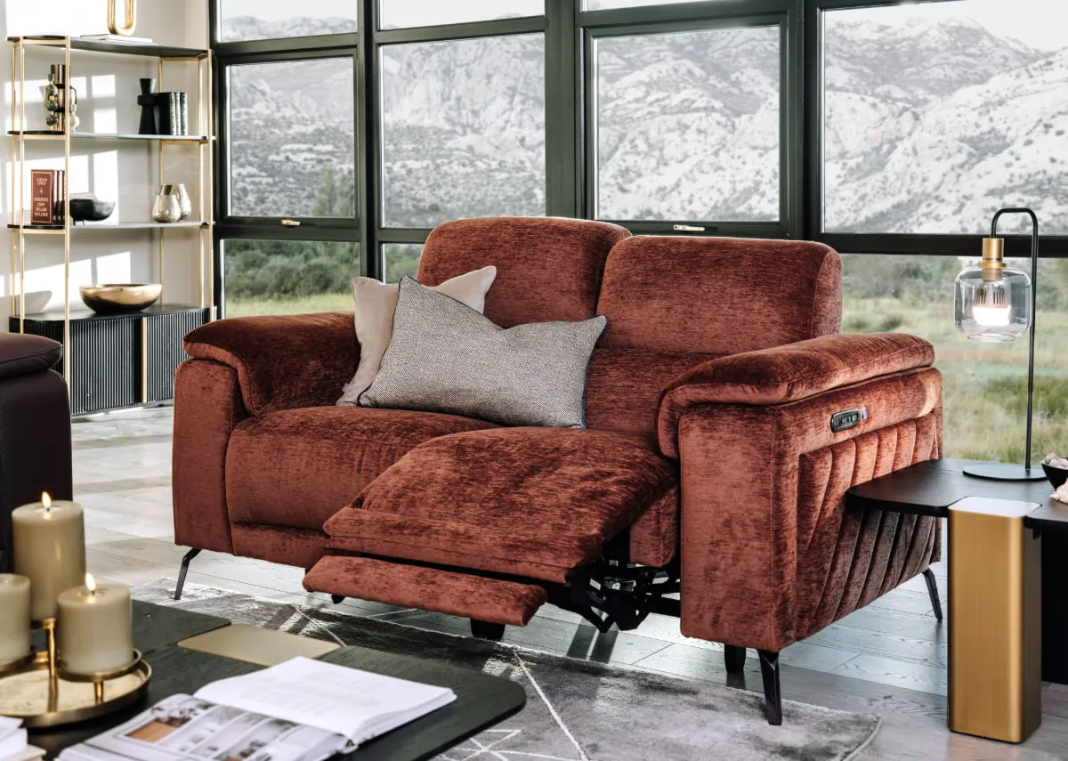 A lifestyle image of the Paige 3 seater sofa with cushions against a large window with echo table