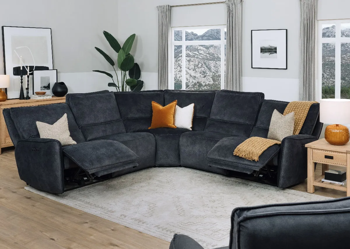 A lifestyle image of the Quentin medium corner sofa reclined with Albany side table and Nizza rug