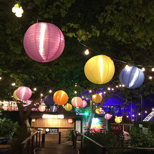 Fairy lights at night with chinese lanterns.