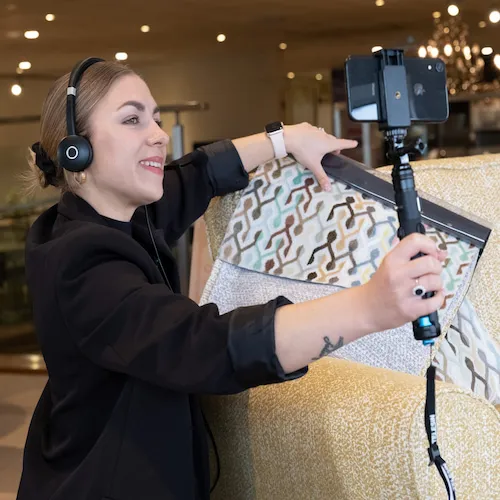 EZ Living Furniture sales advisor shows swatches to customer on camera.