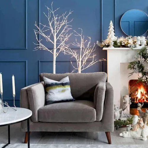 Armchair next to an open fire.
