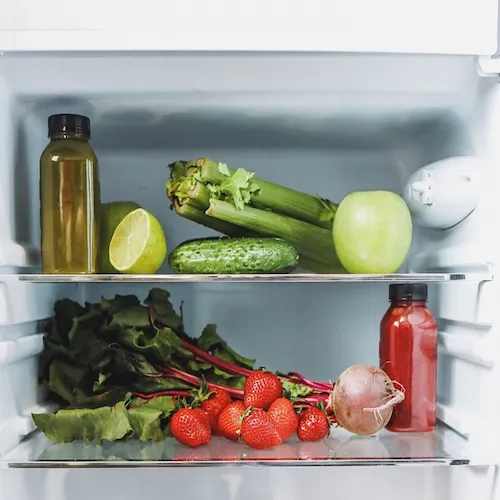 Fridge filled with vegetables.