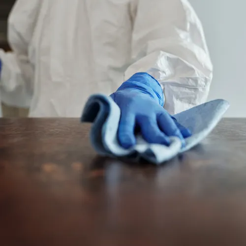 Man cleaning with cloth.