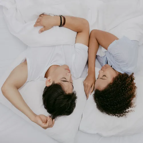 Couple sleeping in bed.
