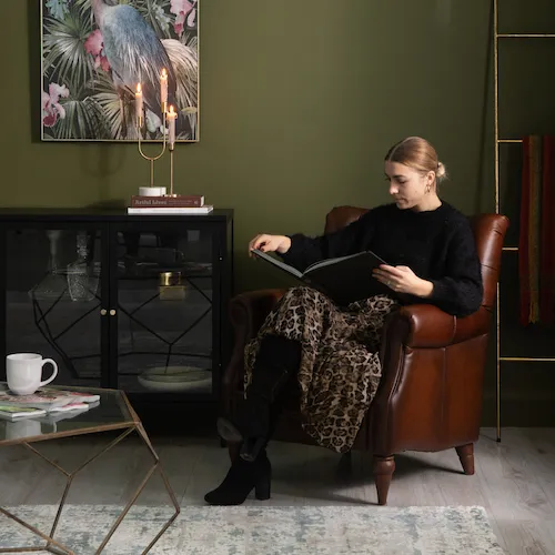 EZ Living Furniture Ola reading a book.