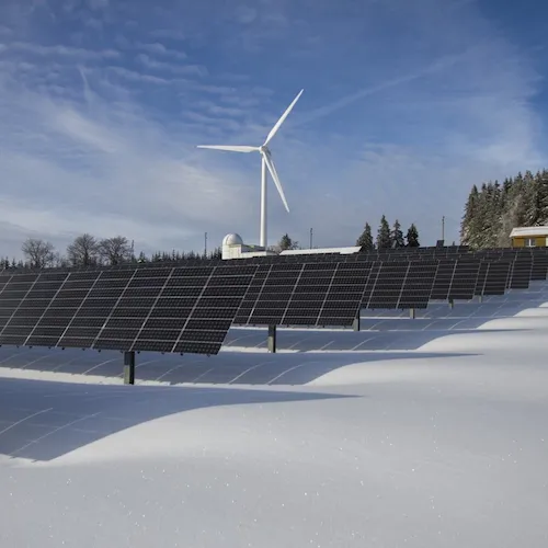 Solar panels with wind turbine.
