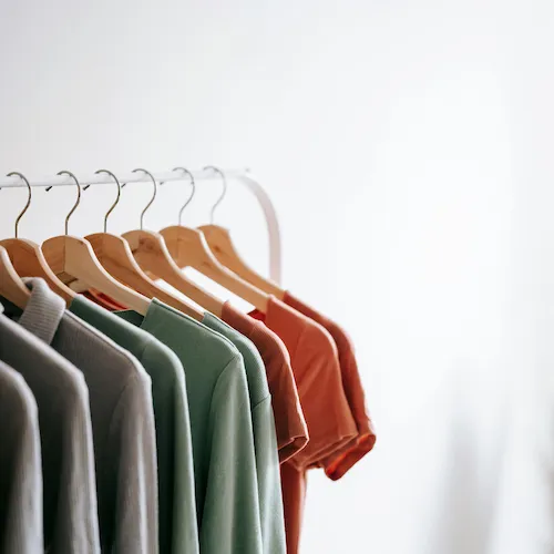Clothing organised on rail.