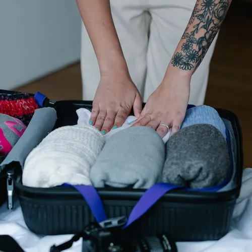 Woman packing her suitcase.