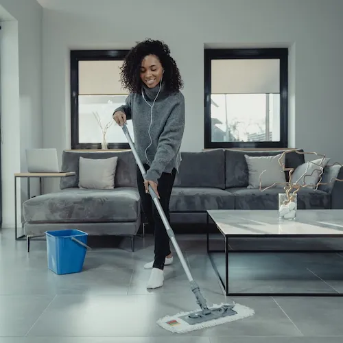 Woman mopping wooden floor.