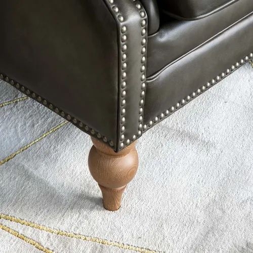 Studded detail on chesterfield Adare wing chair.