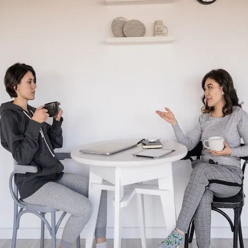 Two women talking casually.