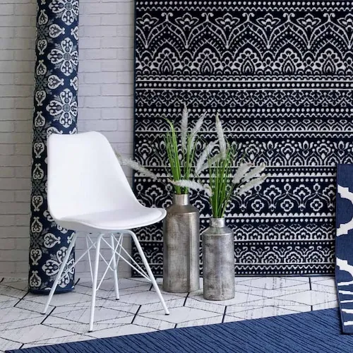White chair and selection of blue and white rugs from EZ Living Furniture.