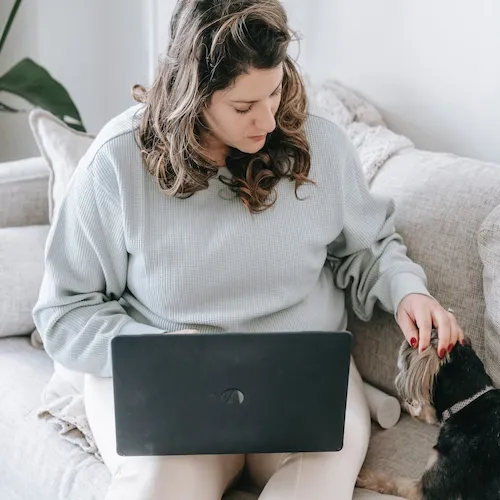 Woman with laptop working from home.