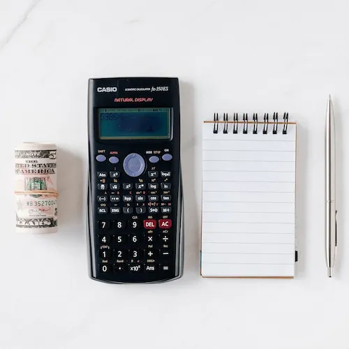 Calculator, cash, pen and notepad.