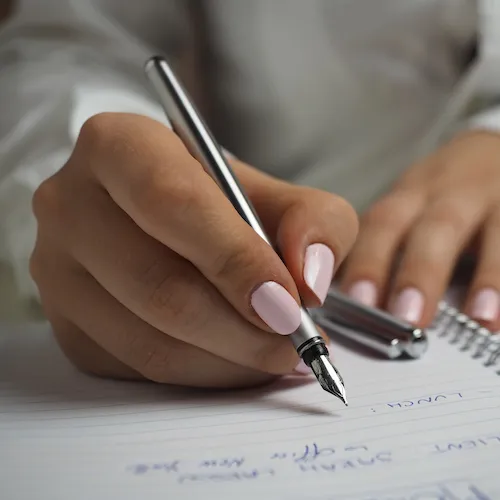 Woman writing shopping list.