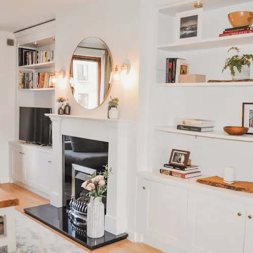 Living room with fireplace design by Wild & Rosie.