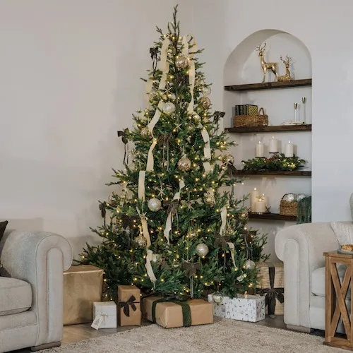 Austria Christmas Tree from EZ Living Furniture decorated with champagne-coloured bows, baubles, and sprays.