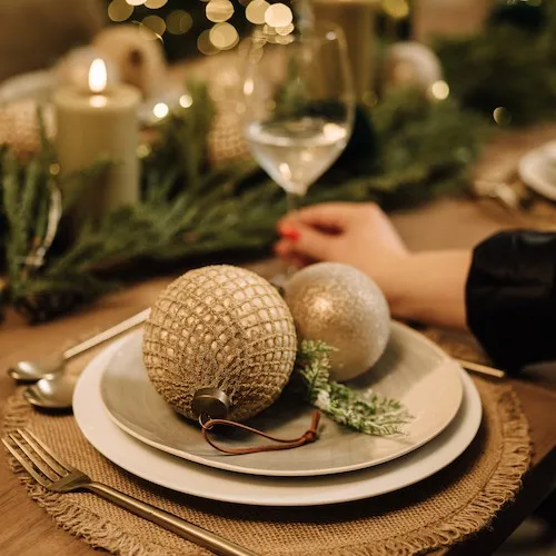 Gold glitter baubles on a dinner plate.